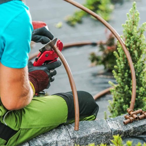 Landscaper Building Drip Irrigation Garden Watering System