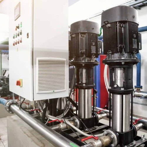 Urban modern powerful pipelines. Industrial pumps in an engine room. Industry interior of water pump